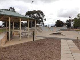 The nearby shelter contains seating and barbecue facilities.