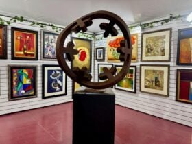 A metal sculpture surrounded by world renown artwork