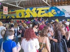 Large crowd shopping vintage under graffiti wall in Adelaideâs coolest warehouse