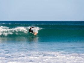 a person surfing on a large wave