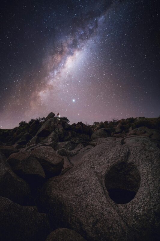 The stars of the Milky Way shine brightly above a rocky cliff at Mannum.