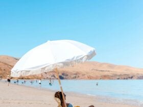 Lady enjoying the beach under umbrella