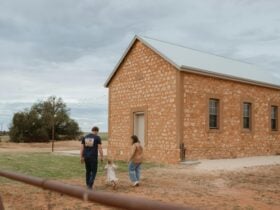 Owners Kiara and Jamie fisher infront of old stone building known as The Bugle Hut
