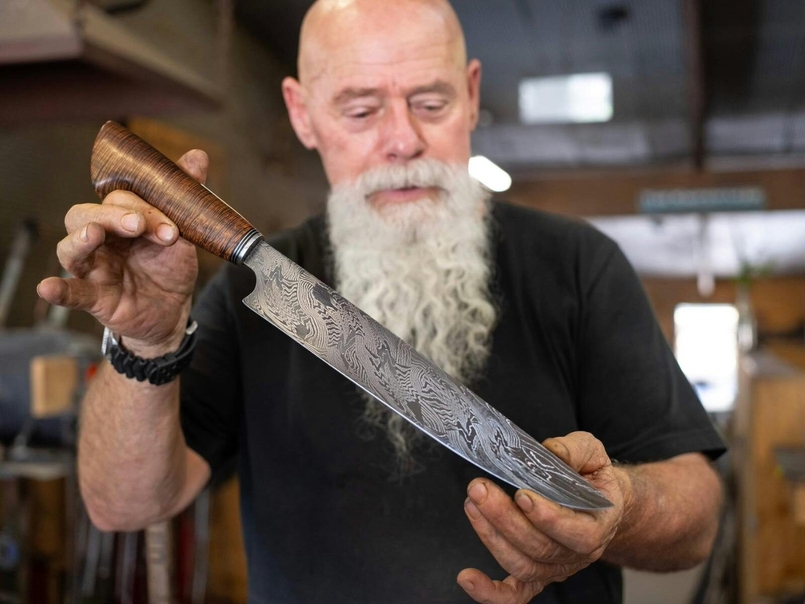 Knifemaker Barry Gardner holding a handmade carving knife.