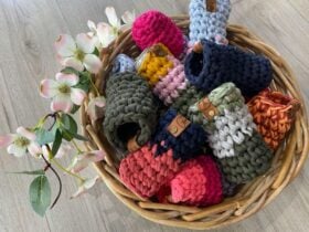 Cane Basket with flowers with a variety of coloured crochet stubby holders