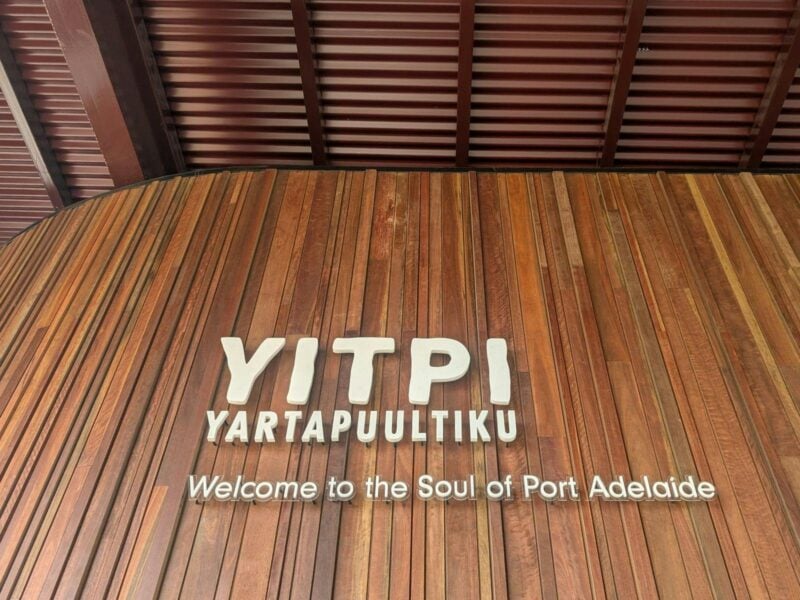 White lettering of the attractions name, Yitpi Yartapuultiku on timber wall cladding