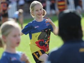 Young girl running at a Gather Round Clinic