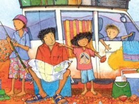 A family of four in the outback, smiling and sitting by their van,