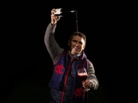 Trent Burge - Barossa Boy - in footy colours pouring the wines