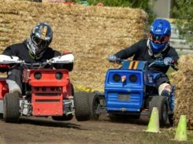 Shows a picture of two fierce competitors battling on the mower track.