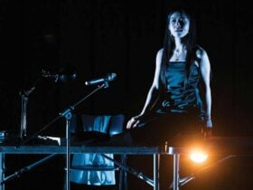 a woman wear dress and stand on the stage