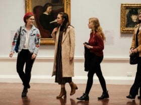 A group of 4 people walking through the gallery