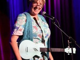 Lori Bell dressed in character as Granny Flaps with a ukulele