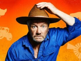 Man with blue button shirt and cowboy hat on orange gradient background with farm items behind him