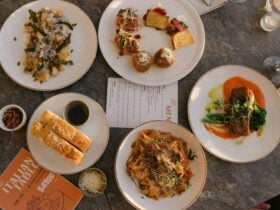 A colourful spread of Italian Food on a table with menus