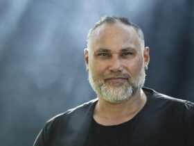 Radical Son in front of a blue-grey background.