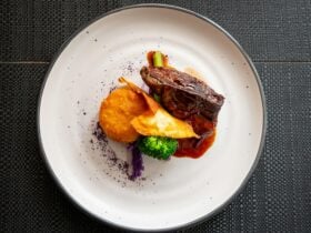 Gourmet main dish of red meat with colourful roast veg