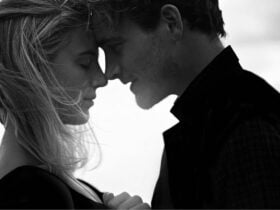two people photographed in black and white embracing each other