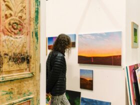 someone looks at a painting in a corner of a studio