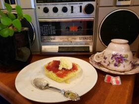Scone with jam and cream in front of an 80s tape deck radio