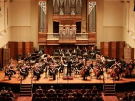 Adelaide SYmphony Orchestra performing on stage at Elder Hall to a large crowd.