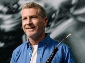 A cor anglais player holds his instrument.