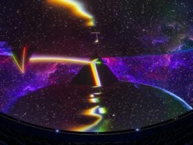 Immersive cosmic scene projected onto a large dome, featuring a prism splitting light into a rainbow
