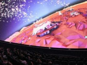 Audiences watching The Planets 360 Reimagined inside the dome, with an animated planet on screen.