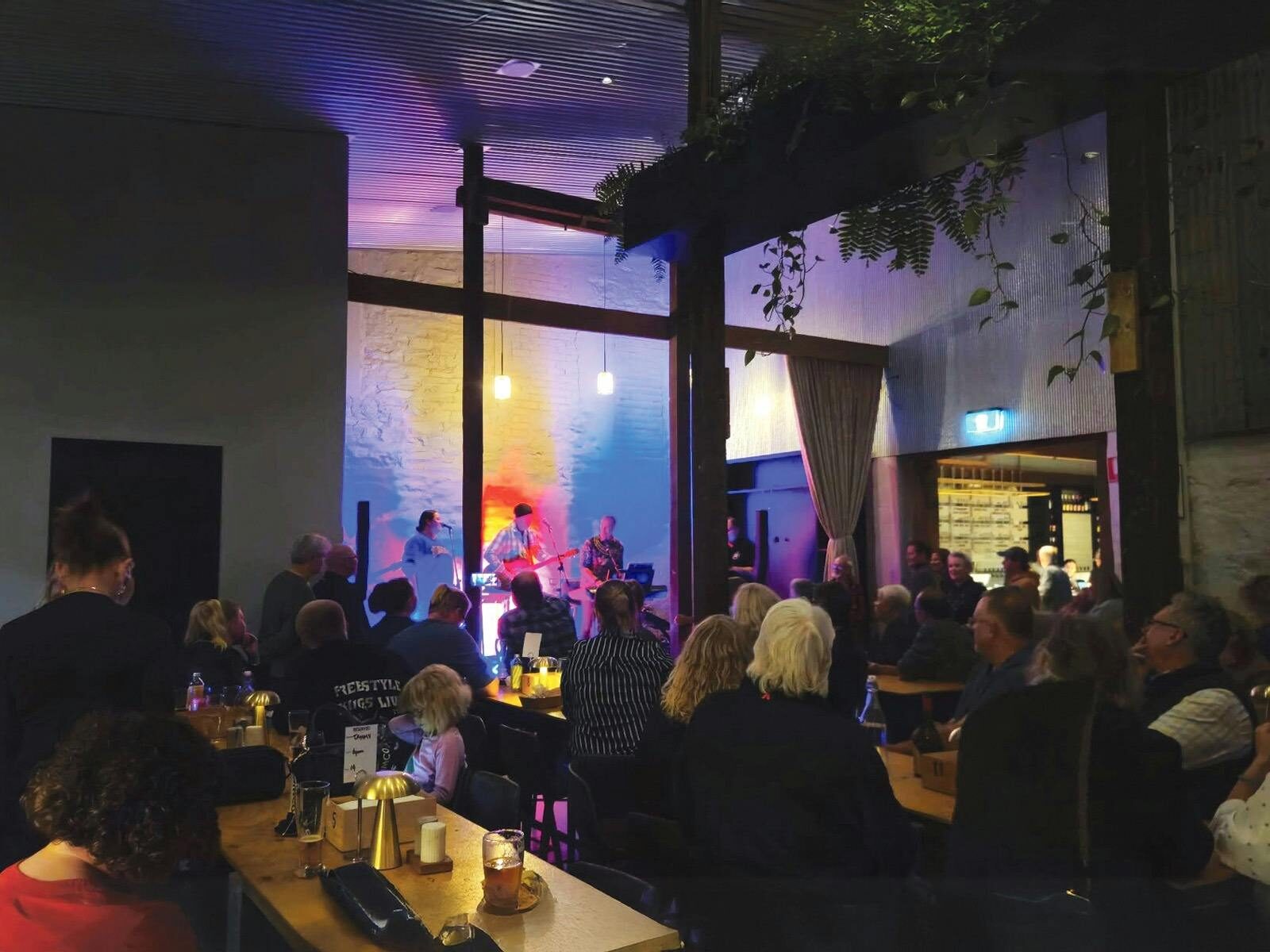 Crowd watching live music inside Old Mill Brewery.
