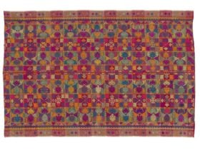 An indonesian clothe featuring a dragon fly motif made up of multiple colours