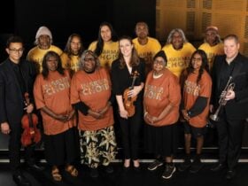 A group of First Nations women standing with ASO players,.
