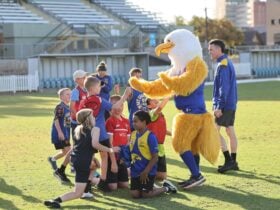 West Coast Eagles mascot playing with children