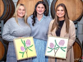 Ladies hold finished artwork