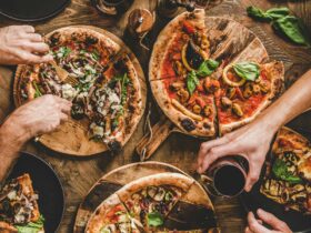 People sharing woodfired pizza dinner