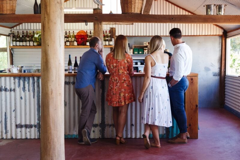 A group of four people enjoy a tasting inside Ashton Hills