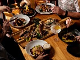 Food on the table with people hands and drinks