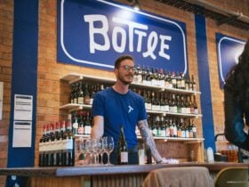 A view of the Bottle Shock bar with a member of staff in the foreground and the wine shelves visible