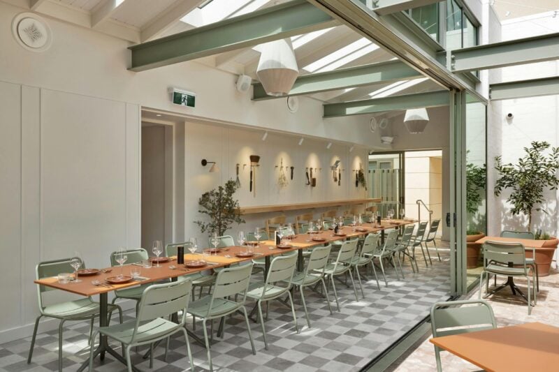 Terracotta tables laid out in a long formation. Set up in the "Garden Shed" space.