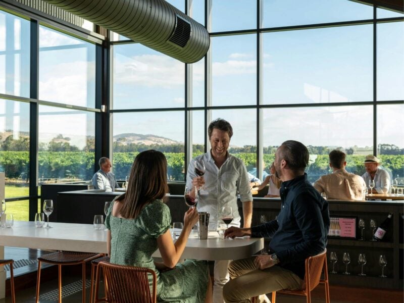 A picture of Tim and John Duval walking through a vineyard