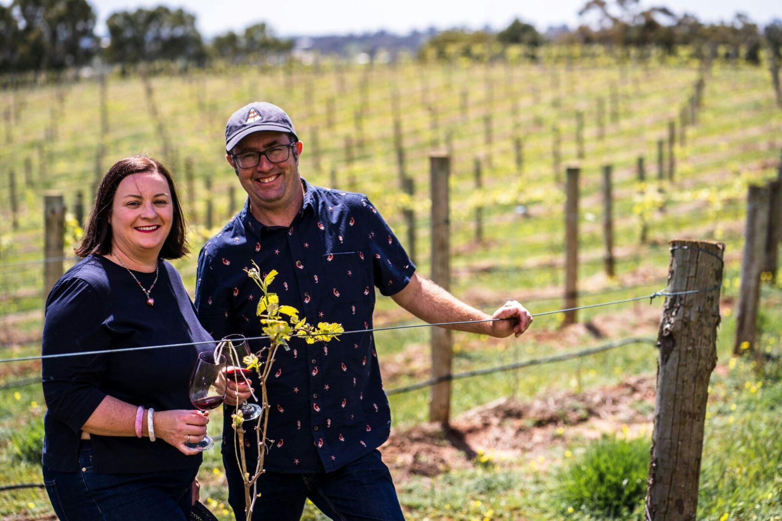 People standing next to vines