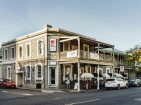 Street view of Saracen's Head Hotel with a classic facade and outdoor seating.