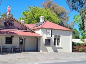 Show the front of the hotel with historic building