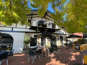 Front of the building showing outdoor tables and chairs