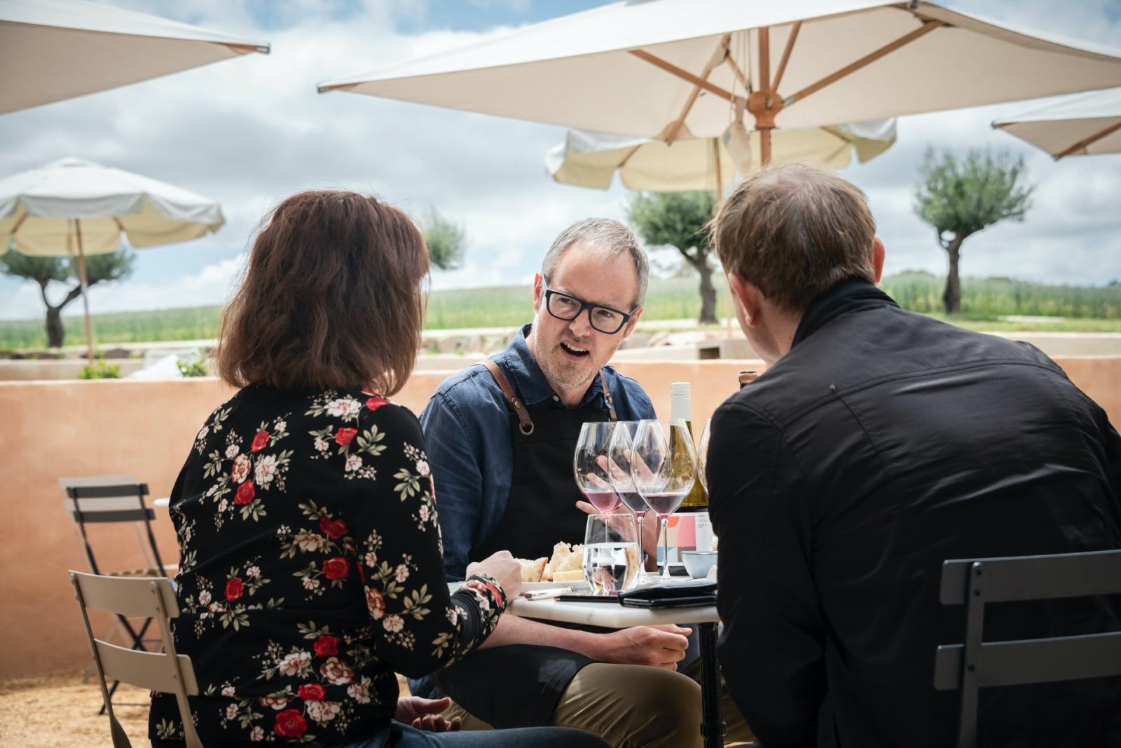 A member of the tasting room team takes visitors through a wine flight