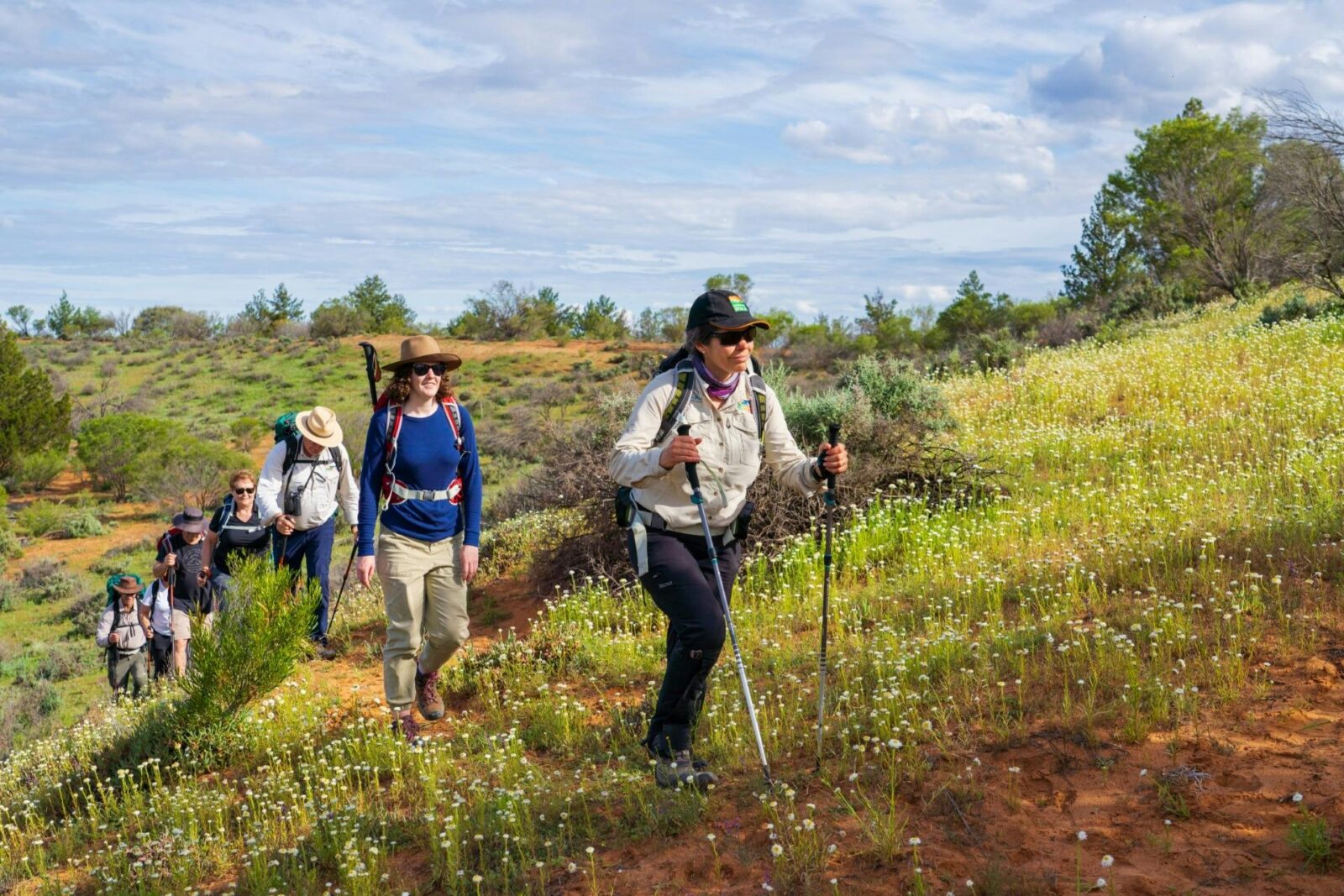 Walking group ascending Headings Cliffs on gentle climb.