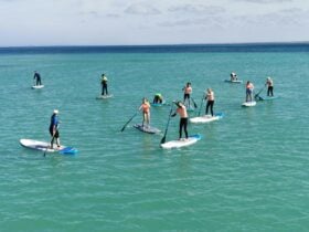International exchange students experience SUP for the first time, at Southend Jetty