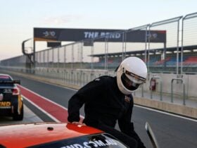 Driver getting into a race car at The Bend Motorsport Park