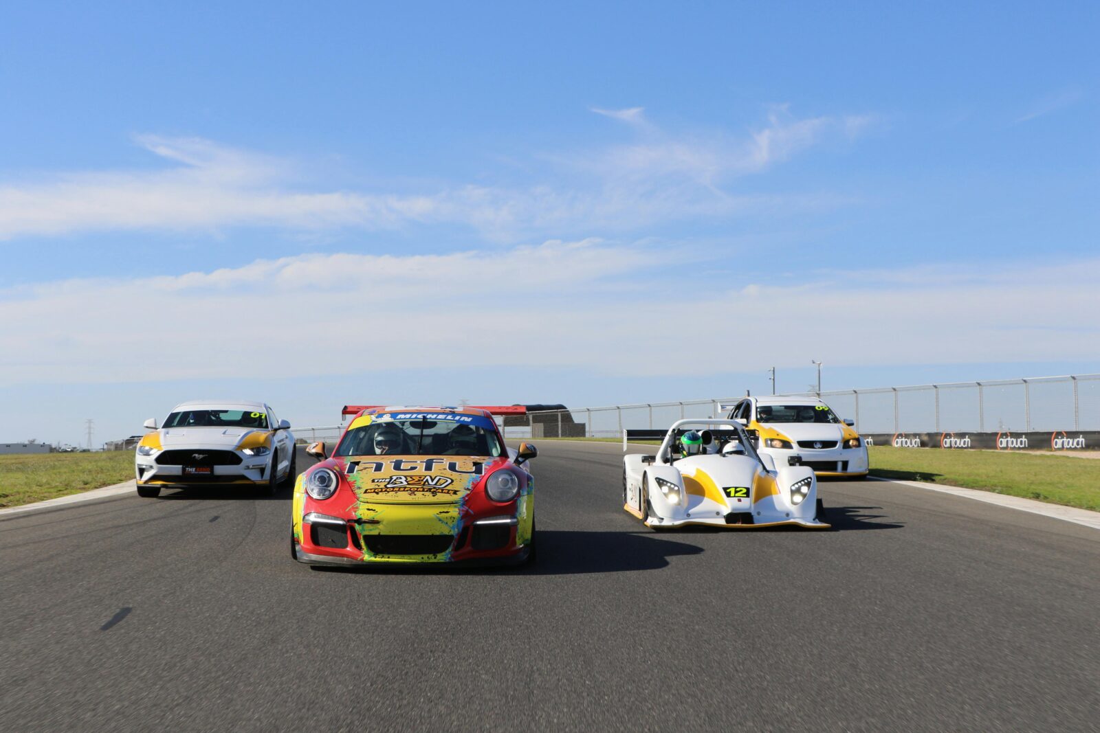 4 race cars on track