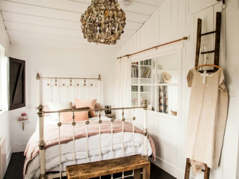 Cosy, warm bedroom with wood features and sculptural chandelier
