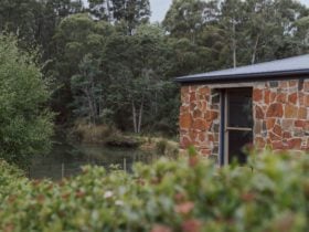 The cottage is built of stone and timber from the property and sits right on the water